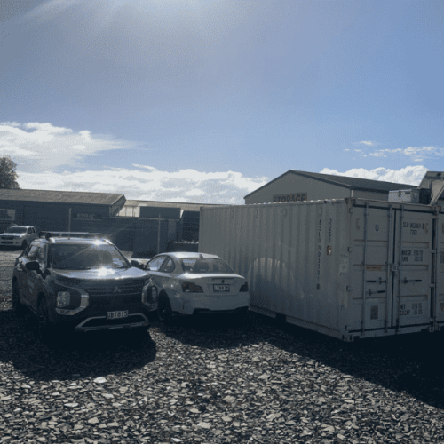 Self storage Hamilton NZ by Storageville - picture of a ute and a car parked alongside a 40ft container to show the scale of the space available.