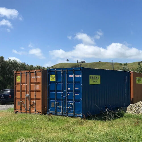 Two shipping containers on a lawn with blue sky behind, indicating that you can buy or hire shipping containers in Northland from Storageville